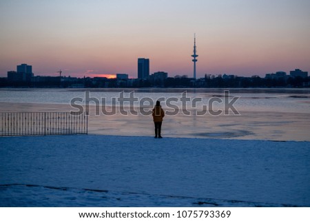 Women alone on the coast in Hamburg Germany; winter landscape; sunset in Hamburg; tv tower