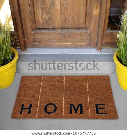 Beautiful Beige and black zute / coir Outdoor Door mat with "H O M E" text and vertical lines outside home with yellow flower pots