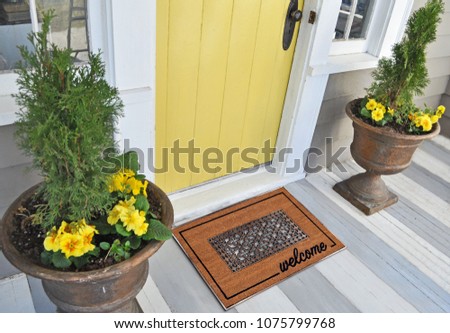 Beautiful Classic beige zute and black rubber border Outdoor Doormat with welcome text outside home with yellow flower pots
