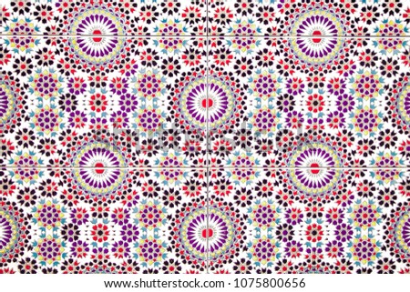 Vintage dutch tile with old pattern. Tiled wall with a colorful bright red and pink colors.