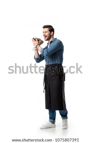 cheerful bartender in apron with shaker in hands isolated on white Royalty-Free Stock Photo #1075807391