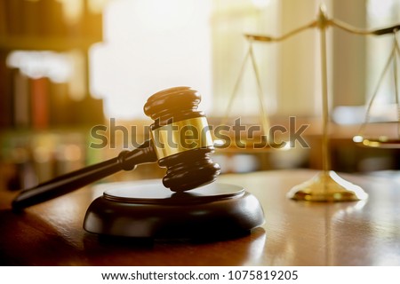 Judge gavel with Justice  lawyers having team meeting at law firm in background. Concepts of law. Royalty-Free Stock Photo #1075819205