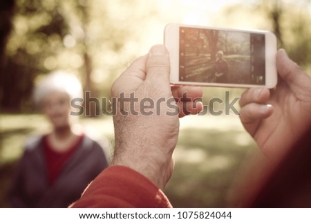 Senior man taking self picture of senior woman.