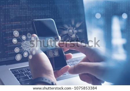 AI, Artificial Intelligence, Big data, Internet of Things IoT. Man, programmer, software engineer using mobile smartphone by id touch on screen, coding on laptop computer with technology background Royalty-Free Stock Photo #1075853384