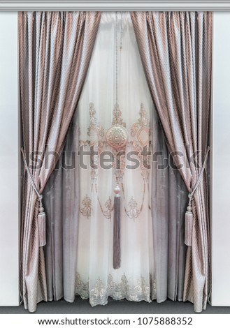 Elegant double curtains made of natural fabrics and a luxurious tulle with ornament Royalty-Free Stock Photo #1075888352
