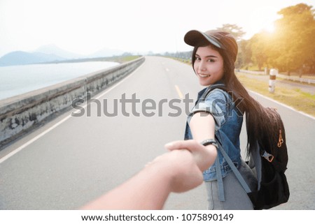 a couple young asian traveler holding hand with backpack while traveling on holiday vacation
