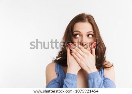 Portrait of a surprised young woman covering mouth with hands isolated over white background Royalty-Free Stock Photo #1075921454