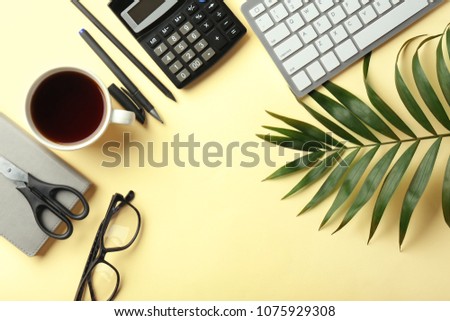 Computer keyboard, cup of coffee and calculator on color background, flat lay. Workplace table composition
