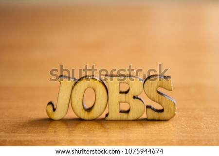 The word 'jobs' made of wooden letters. wood inscription on table
