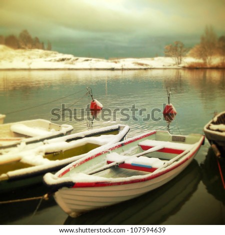 Retro postcard with boats under snow