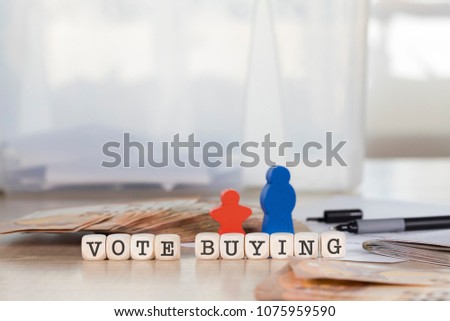 Word VOTE  BUYING composed of wooden letters. Closeup