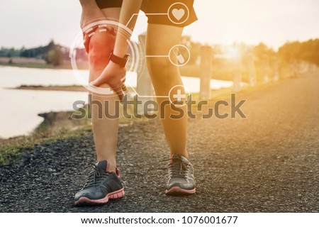 Runners leg pain, man holding sore and over trained painful leg muscle or cramp .Injured over trained person when exercising or running jogging outdoors. Royalty-Free Stock Photo #1076001677