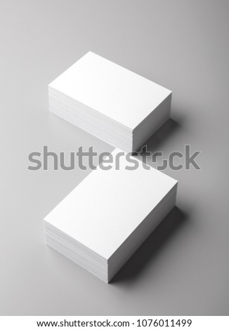 Photo of white business cards. Template for branding identity. For graphic designers presentations and portfolios. Business Card isolated on gray. White business card mock-up. Photo mock up.