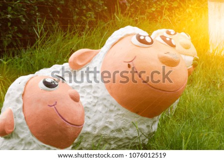Sheep statue and sunset.