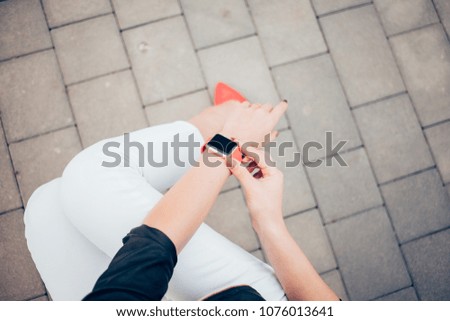 Photo of female hands touching screen generic design smart watch. Film effects, blurred background