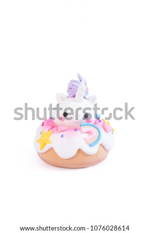 Unicorn donut isolated on a white background. Gingerbread doughnut with a baby unicorn made from sugar icing.