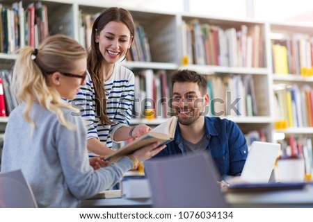 University students working in the library at campus Royalty-Free Stock Photo #1076034134