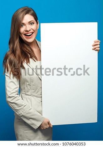 Positive emotional woman holding white banner. Portrait on blue.