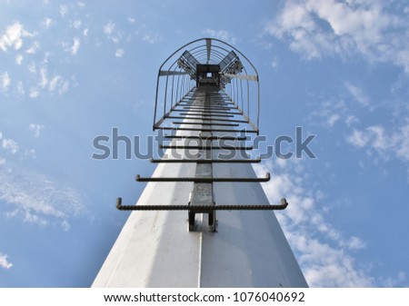 Pole of spotlight with fixed ladder in stadium. Ant's eyes view.