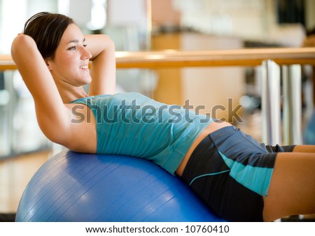A young woman working out in a gym Royalty-Free Stock Photo #10760410