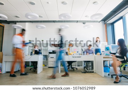 blurred portrait of rushing employees in working time