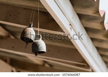 Small bell hanging under the temple roof in Wat Hong Thong Chachoengsao, Thailand
