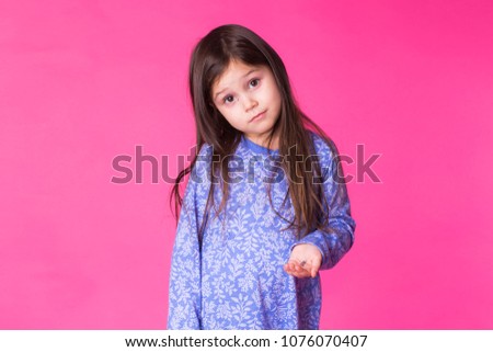 Portrait of adorable little girl isolated on a pink background