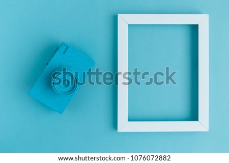 Retro film photo camera colored in blue with photo frame minimal abstract creative concept. Place for photo adding.