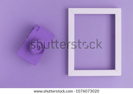 Retro film photo camera colored in purple with photo frame minimal abstract creative concept. Place for photo adding.