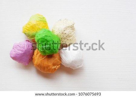 Colorful crumpled plastic bag on white background.