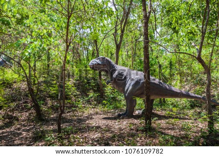 Dinosaur statue in the forest park , Dinosaur statue image in nature.