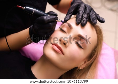 Permanent make up on eyebrows. Royalty-Free Stock Photo #1076113799
