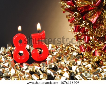 Abstract Background for birthday or anniversary. Red candles showing Nr. 85    
