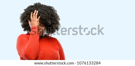 Beautiful african woman stressful keeping hand on head, tired and frustrated, blue background Royalty-Free Stock Photo #1076133284