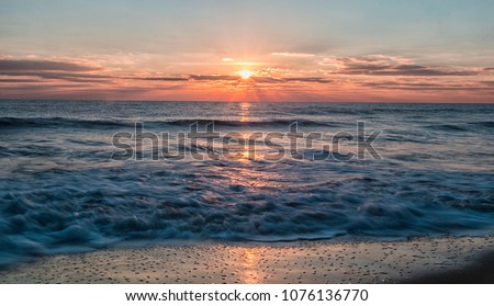Ocean City Maryland sunrise over the Atlantic Ocean Royalty-Free Stock Photo #1076136770