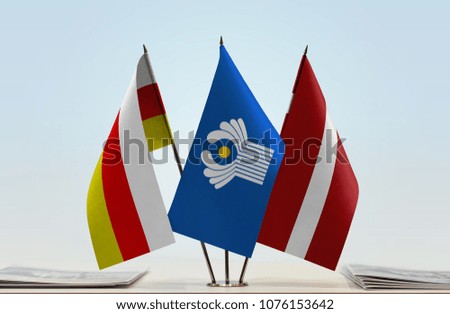 Flags of South Ossetia CIS and Latvia. Cloth of flags is 3d rendering, the rest is a photo.
