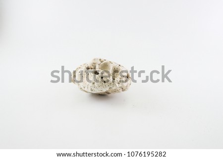Shaped stone surfaces from corrosion of a natural path on a white background.