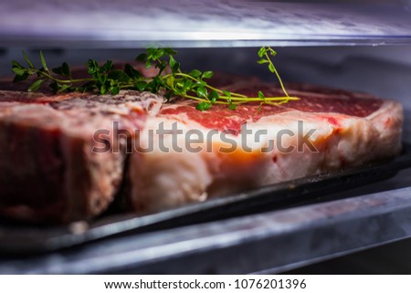 dry aged beef in refrigerator Royalty-Free Stock Photo #1076201396