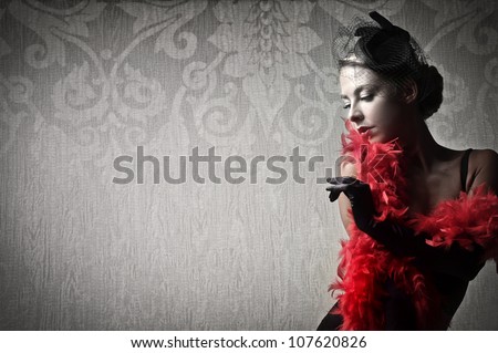 Beautiful woman wearing a red feather boa