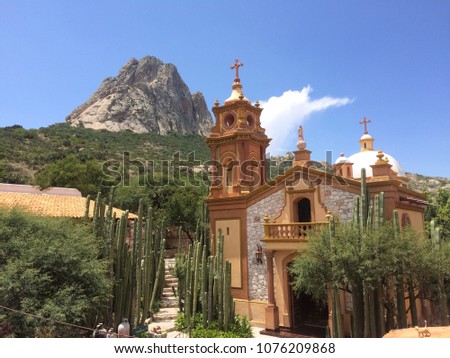 Sunny afternoon in Peña de Bernal, Querétaro. Church on the slopes of the rock Royalty-Free Stock Photo #1076209868