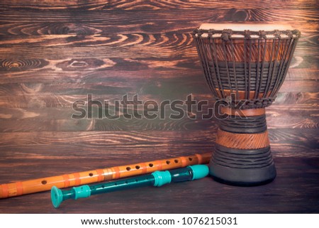 flute and drum on wooden background