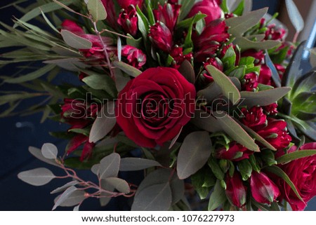 Bouquet of red roses and eucalyptus