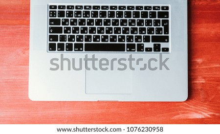 Computer pc stands on a wooden red background