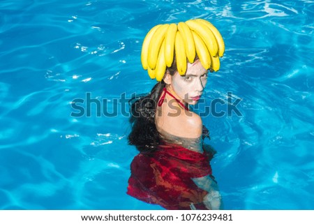 pretty woman relax in spa luxury swimming pool. pretty woman with banana on head.