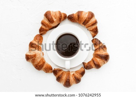 croissants with a cup of coffee on a white background