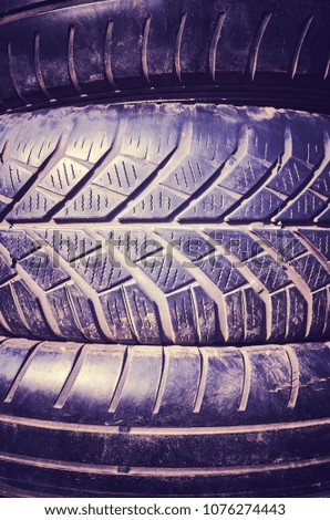Vintage toned close up picture of used car tires.