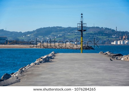 Photo of a Spanish port with blue sky, sea and sunlight