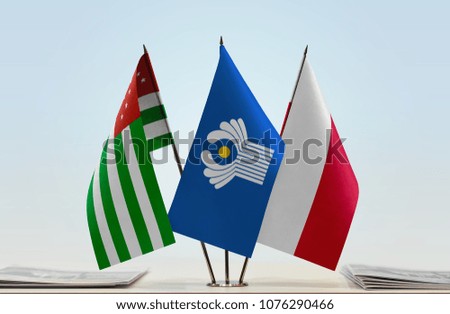 Flags of Abkhazia CIS and Poland. Cloth of flags is 3d rendering, the rest is a photo.