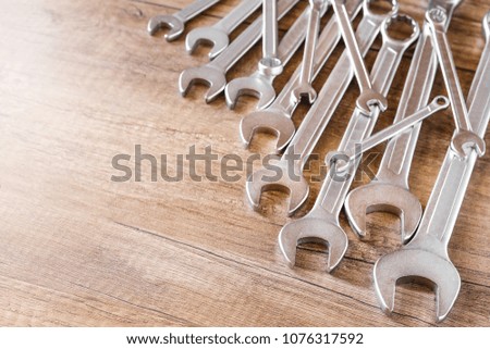 A lot of wrenches. The working set of wrenches on wooden background. Tooling.