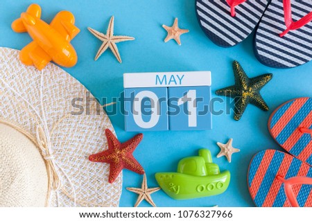 May 1st. Image of may 1 calendar with summer beach accessories and traveler outfit on background. Spring like Summer vacation concept